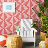 Parasol wallpaper is designed with overlapping shapes of multicolored beach umbrellas. Highly durable, fade resistant, and made in the USA. This wallpaper has a coral print on a pink background and is designed in collaboration with The Aesthetics of Joy.