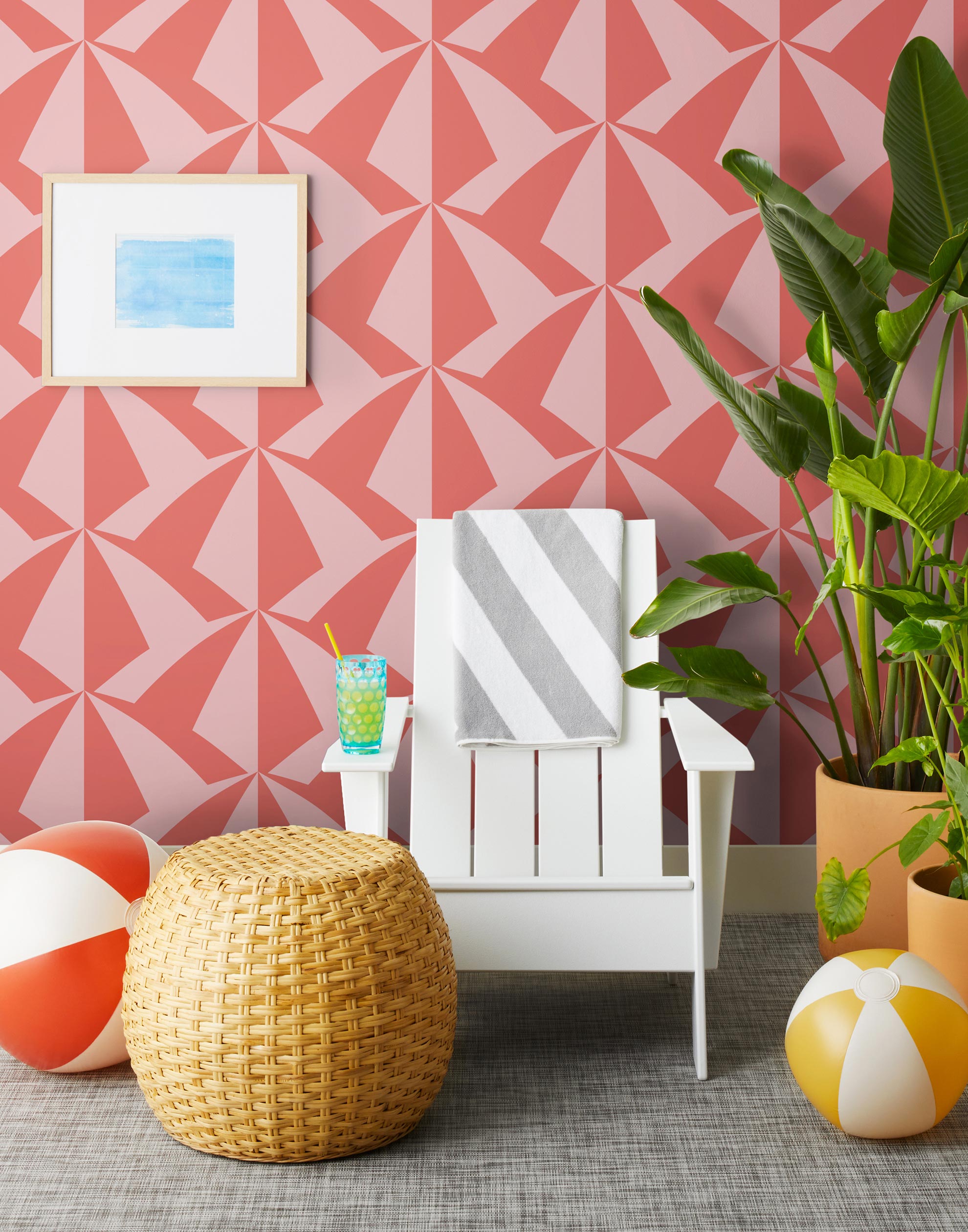 Parasol wallpaper is designed with overlapping shapes of multicolored beach umbrellas. Highly durable, fade resistant, and made in the USA. This wallpaper has a coral print on a pink background and is designed in collaboration with The Aesthetics of Joy.