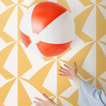 Parasol wallpaper is designed with overlapping shapes of multicolored beach umbrellas. Highly durable, fade resistant, and made in the USA. This wallpaper has a yellow print on white background and is designed in collaboration with The Aesthetics of Joy.