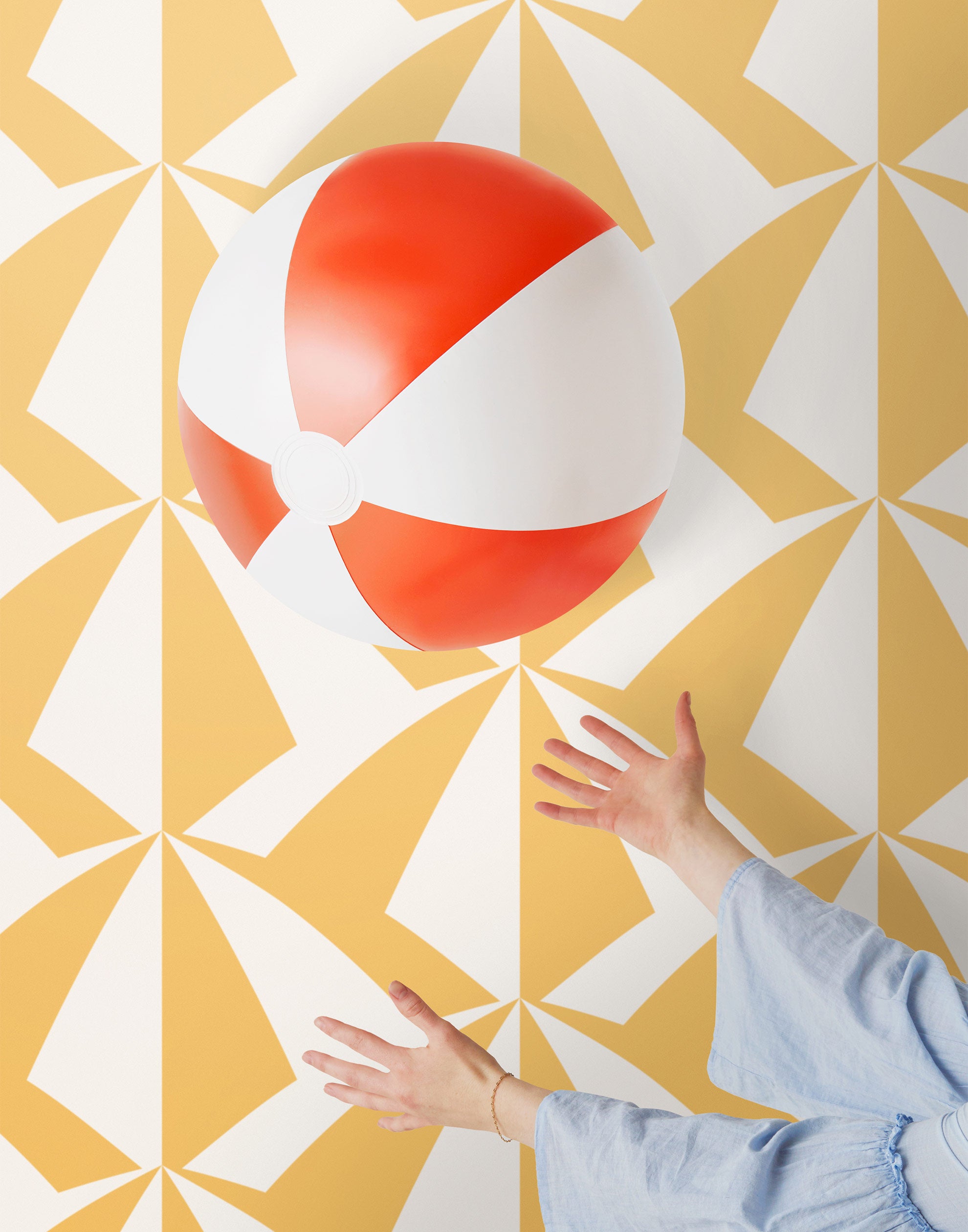 Parasol wallpaper is designed with overlapping shapes of multicolored beach umbrellas. Highly durable, fade resistant, and made in the USA. This wallpaper has a yellow print on white background and is designed in collaboration with The Aesthetics of Joy.
