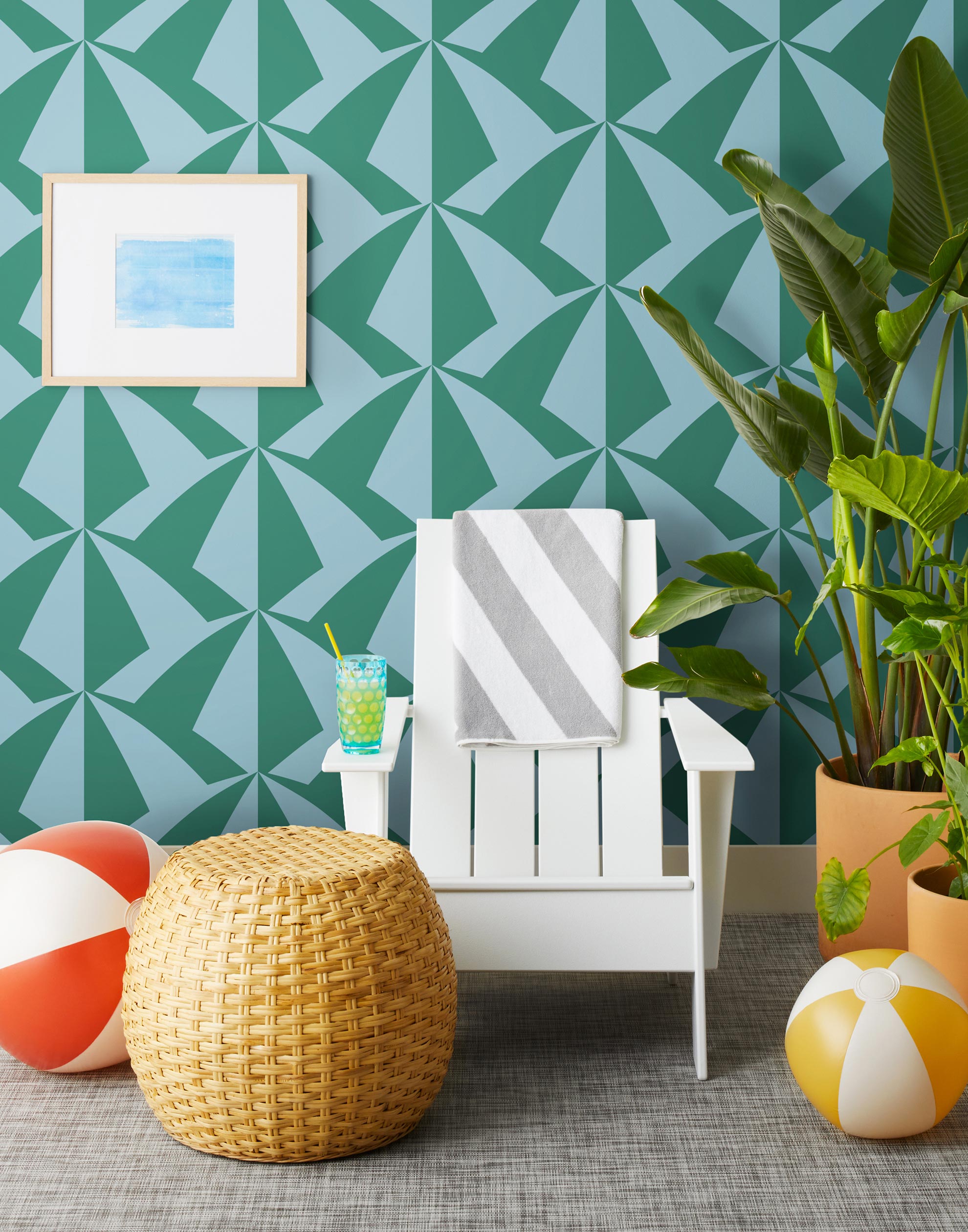 Parasol wallpaper is designed with overlapping shapes of multicolored beach umbrellas. Highly durable, fade resistant, and made in the USA. This wallpaper has a green print on a light blue background and is designed in collaboration with The Aesthetics of Joy.