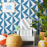 Parasol wallpaper is designed with overlapping shapes of multicolored beach umbrellas. Highly durable, fade resistant, and made in the USA. This wallpaper has a blue print on a white background and is designed in collaboration with The Aesthetics of Joy.