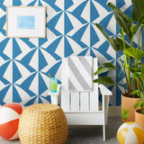 Parasol wallpaper is designed with overlapping shapes of multicolored beach umbrellas. Highly durable, fade resistant, and made in the USA. This wallpaper has a blue print on a white background and is designed in collaboration with The Aesthetics of Joy.