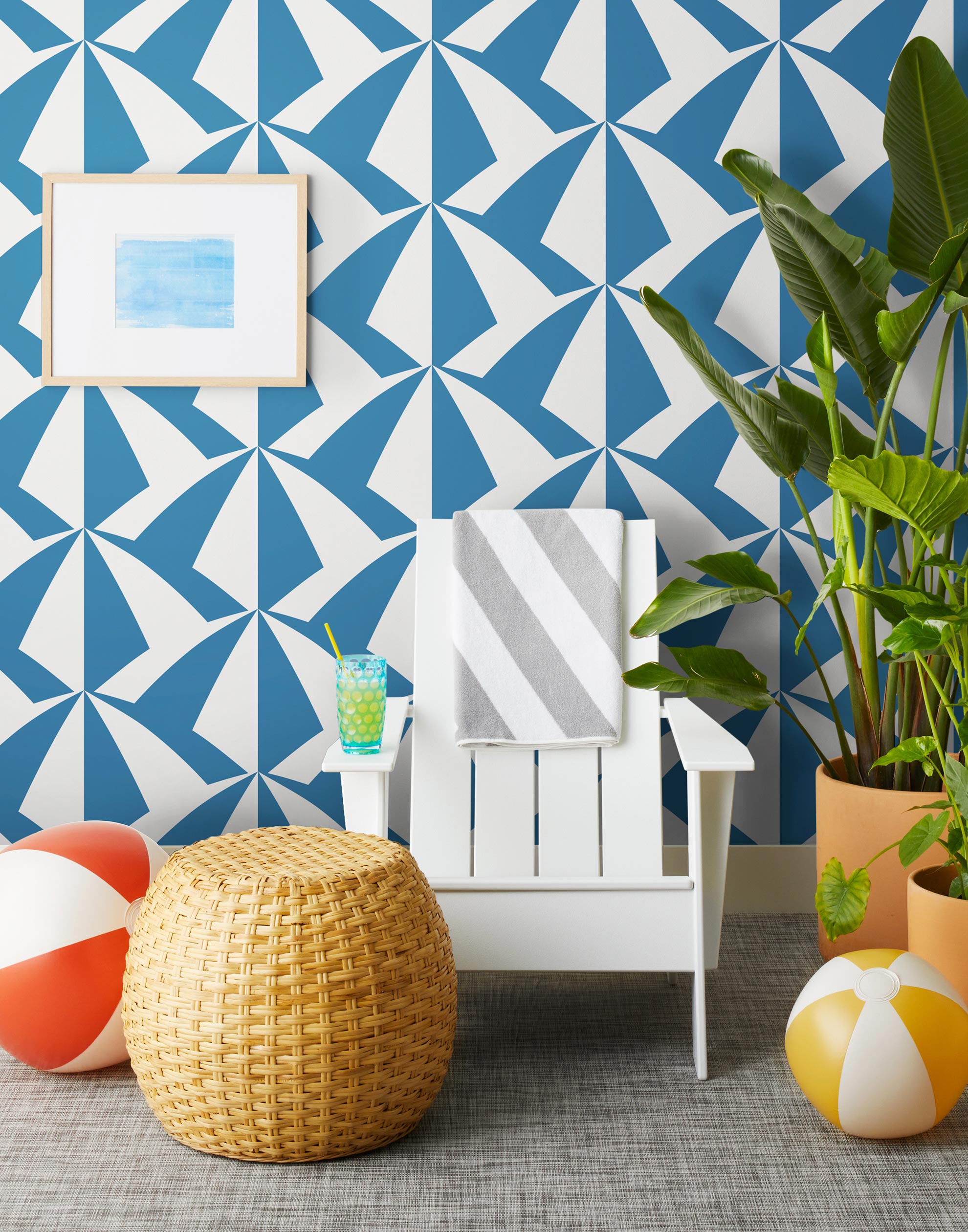 Parasol wallpaper is designed with overlapping shapes of multicolored beach umbrellas. Highly durable, fade resistant, and made in the USA. This wallpaper has a blue print on a white background and is designed in collaboration with The Aesthetics of Joy.