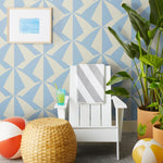 Parasol wallpaper is designed with overlapping shapes of multicolored beach umbrellas. Highly durable, fade resistant, and made in the USA. This wallpaper has a blue print on a cream background and is designed in collaboration with The Aesthetics of Joy.