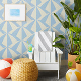 Parasol wallpaper is designed with overlapping shapes of multicolored beach umbrellas. Highly durable, fade resistant, and made in the USA. This wallpaper has a blue print on a cream background and is designed in collaboration with The Aesthetics of Joy.