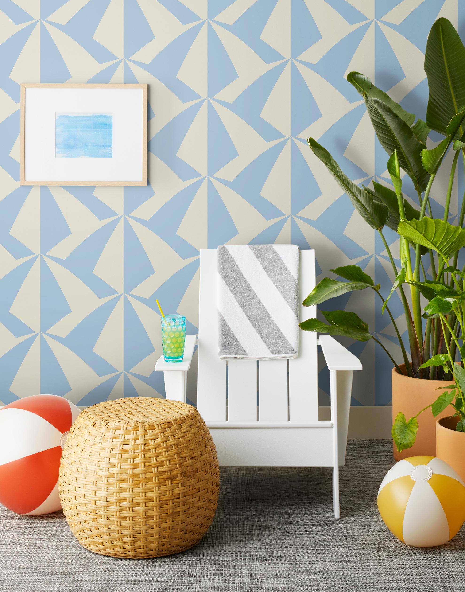 Parasol wallpaper is designed with overlapping shapes of multicolored beach umbrellas. Highly durable, fade resistant, and made in the USA. This wallpaper has a blue print on a cream background and is designed in collaboration with The Aesthetics of Joy.