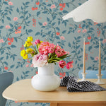 Our Heirloom wallpaper celebrates the annual arrival of tomato season. Highly durable, fade resistant, and made in the USA. This wallpaper features red and peach tomatoes, pink flowers and blue vines on a light blue background and was created in collaboration with The Aesthetics of Joy.