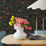 Our Heirloom wallpaper celebrates the annual arrival of tomato season. Highly durable, fade resistant, and made in the USA. This wallpaper features red and orange tomatoes, pink flowers and green vines on a black background and was created in collaboration with The Aesthetics of Joy.