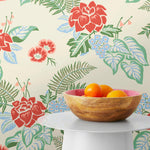 Our Lanai wallpaper is inspired by the rich tradition and exuberant patterns of Hawaiian shirts, with a twist. Highly durable, fade resistant, and made in the USA. This wallpaper features red flowers with green and blue leaves on a cream background and was created in collaboration with The Aesthetics of Joy.