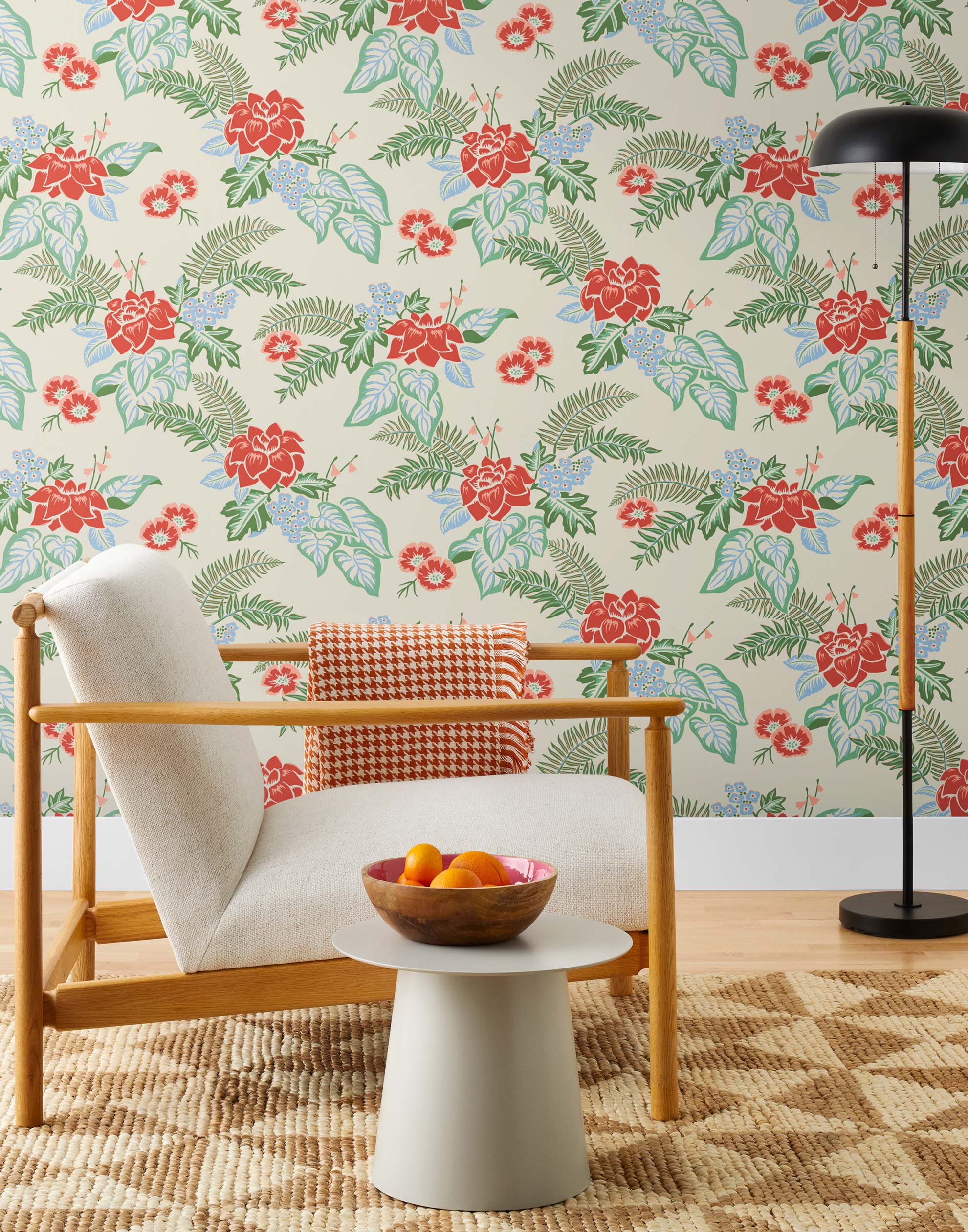 Our Lanai wallpaper is inspired by the rich tradition and exuberant patterns of Hawaiian shirts, with a twist. Highly durable, fade resistant, and made in the USA. This wallpaper features red flowers with green and blue leaves on a cream background and was created in collaboration with The Aesthetics of Joy.