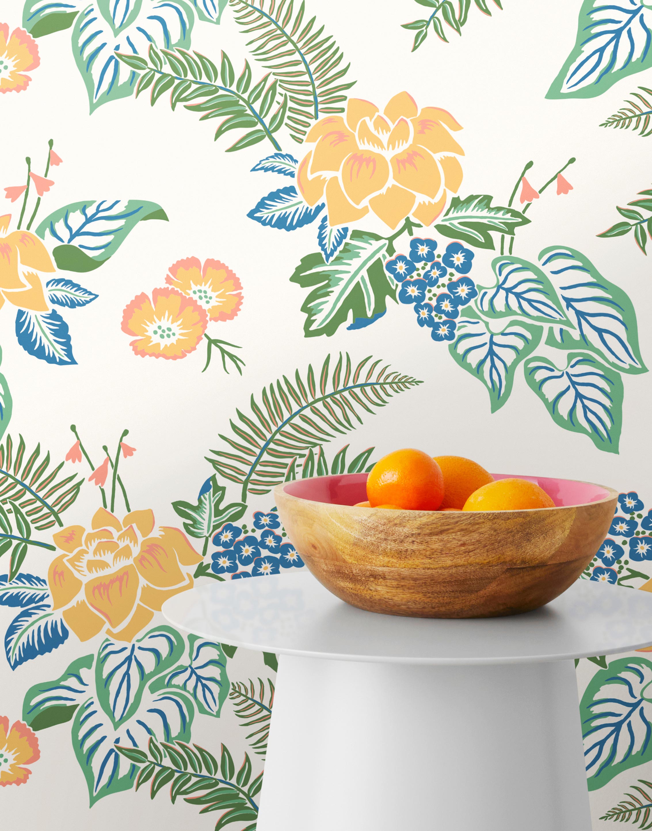 Our Lanai wallpaper is inspired by the rich tradition and exuberant patterns of Hawaiian shirts, with a twist. Highly durable, fade resistant, and made in the USA. This wallpaper features yellow flowers with green and blue leaves on a white background and was created in collaboration with The Aesthetics of Joy.
