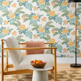Our Lanai wallpaper is inspired by the rich tradition and exuberant patterns of Hawaiian shirts, with a twist. Highly durable, fade resistant, and made in the USA. This wallpaper features yellow flowers with green and blue leaves on a white background and was created in collaboration with The Aesthetics of Joy.