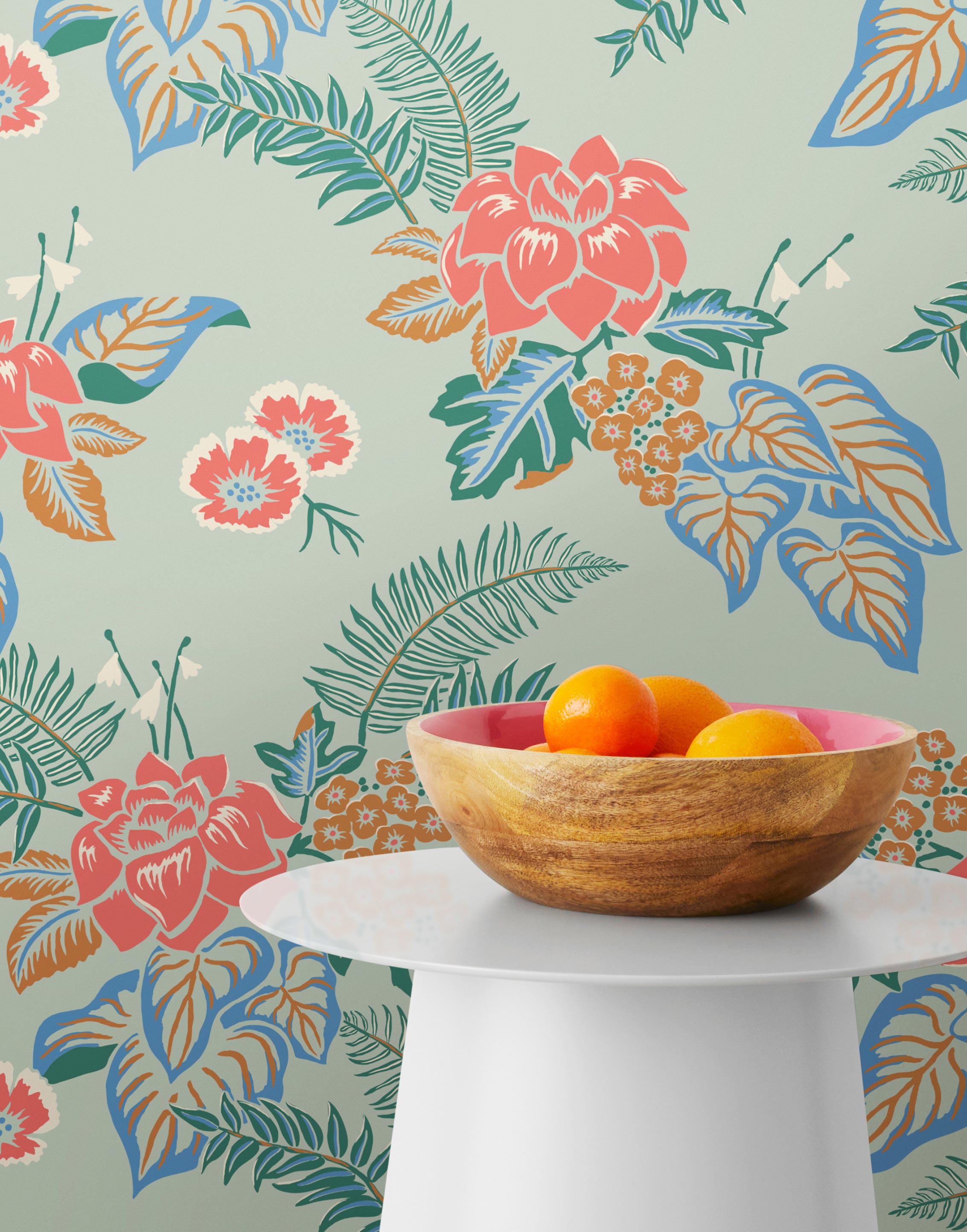 Our Lanai wallpaper is inspired by the rich tradition and exuberant patterns of Hawaiian shirts, with a twist. Highly durable, fade resistant, and made in the USA. This wallpaper features pink flowers with green and blue leaves on a mint green background and was created in collaboration with The Aesthetics of Joy.