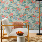 Our Lanai wallpaper is inspired by the rich tradition and exuberant patterns of Hawaiian shirts, with a twist. Highly durable, fade resistant, and made in the USA. This wallpaper features pink flowers with green and blue leaves on a mint green background and was created in collaboration with The Aesthetics of Joy.