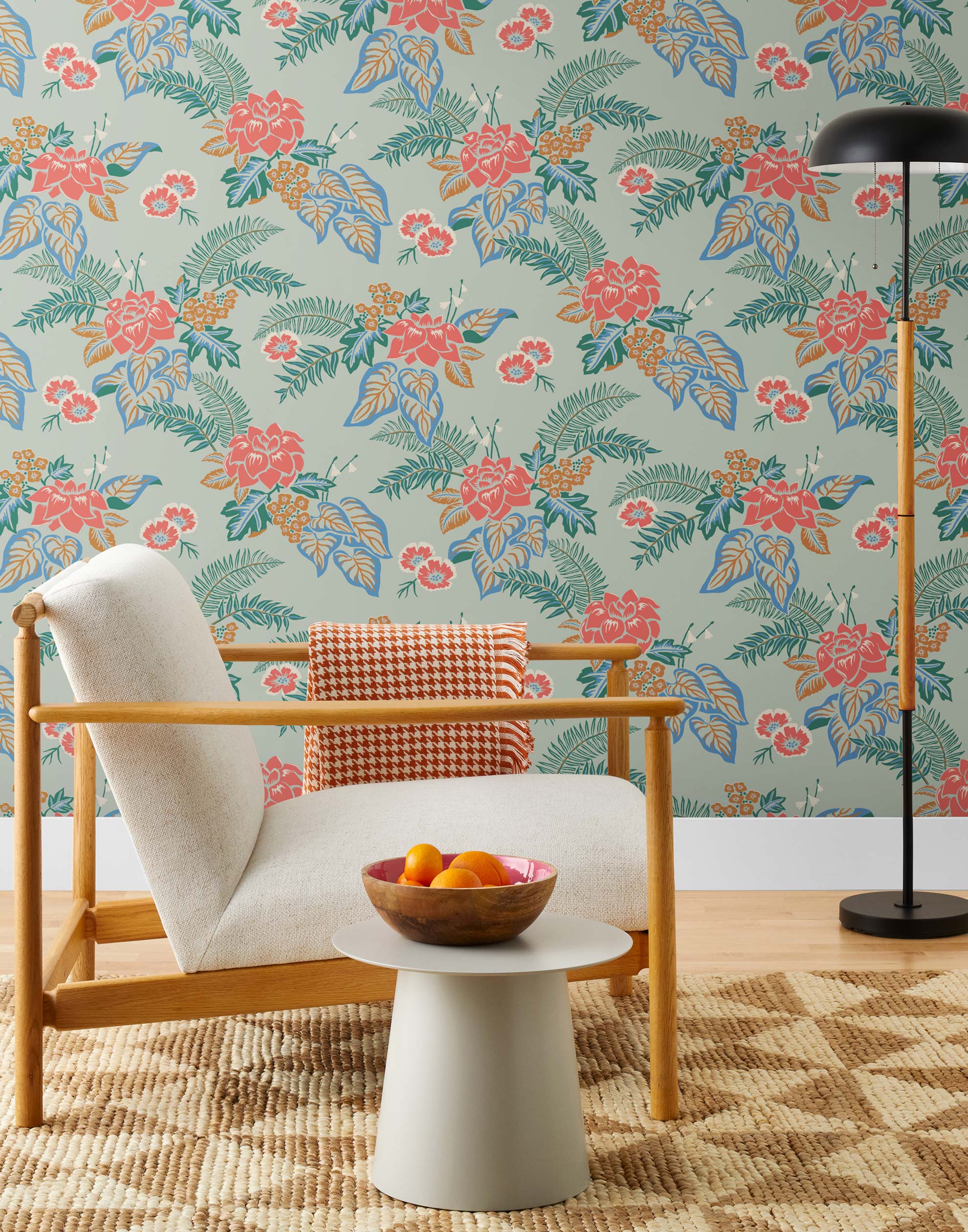 Our Lanai wallpaper is inspired by the rich tradition and exuberant patterns of Hawaiian shirts, with a twist. Highly durable, fade resistant, and made in the USA. This wallpaper features pink flowers with green and blue leaves on a mint green background and was created in collaboration with The Aesthetics of Joy.