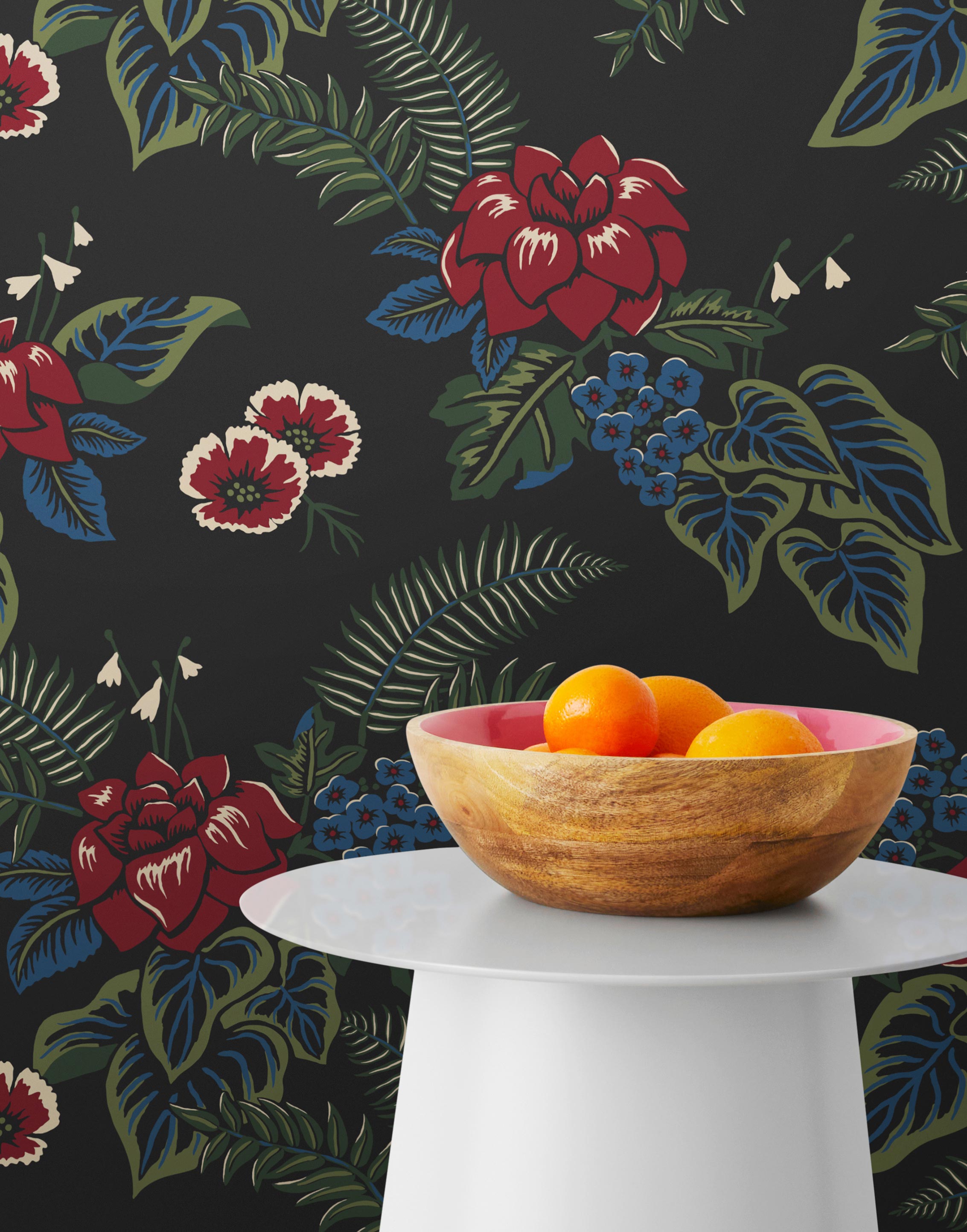 Our Lanai wallpaper is inspired by the rich tradition and exuberant patterns of Hawaiian shirts, with a twist. Highly durable, fade resistant, and made in the USA. This wallpaper features red flowers with green and blue leaves on a black background and was created in collaboration with The Aesthetics of Joy.