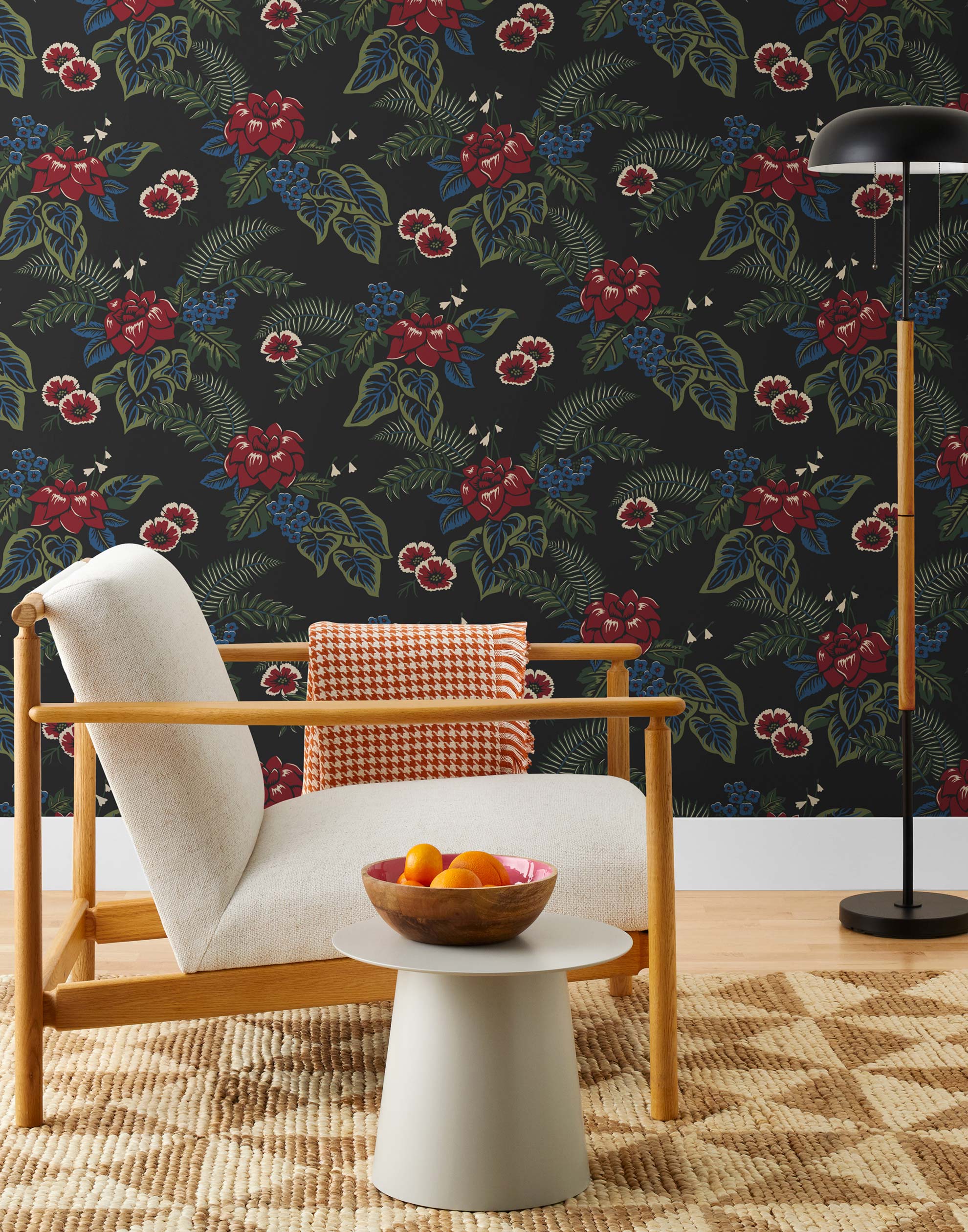 Our Lanai wallpaper is inspired by the rich tradition and exuberant patterns of Hawaiian shirts, with a twist. Highly durable, fade resistant, and made in the USA. This wallpaper features red flowers with green and blue leaves on a black background and was created in collaboration with The Aesthetics of Joy.