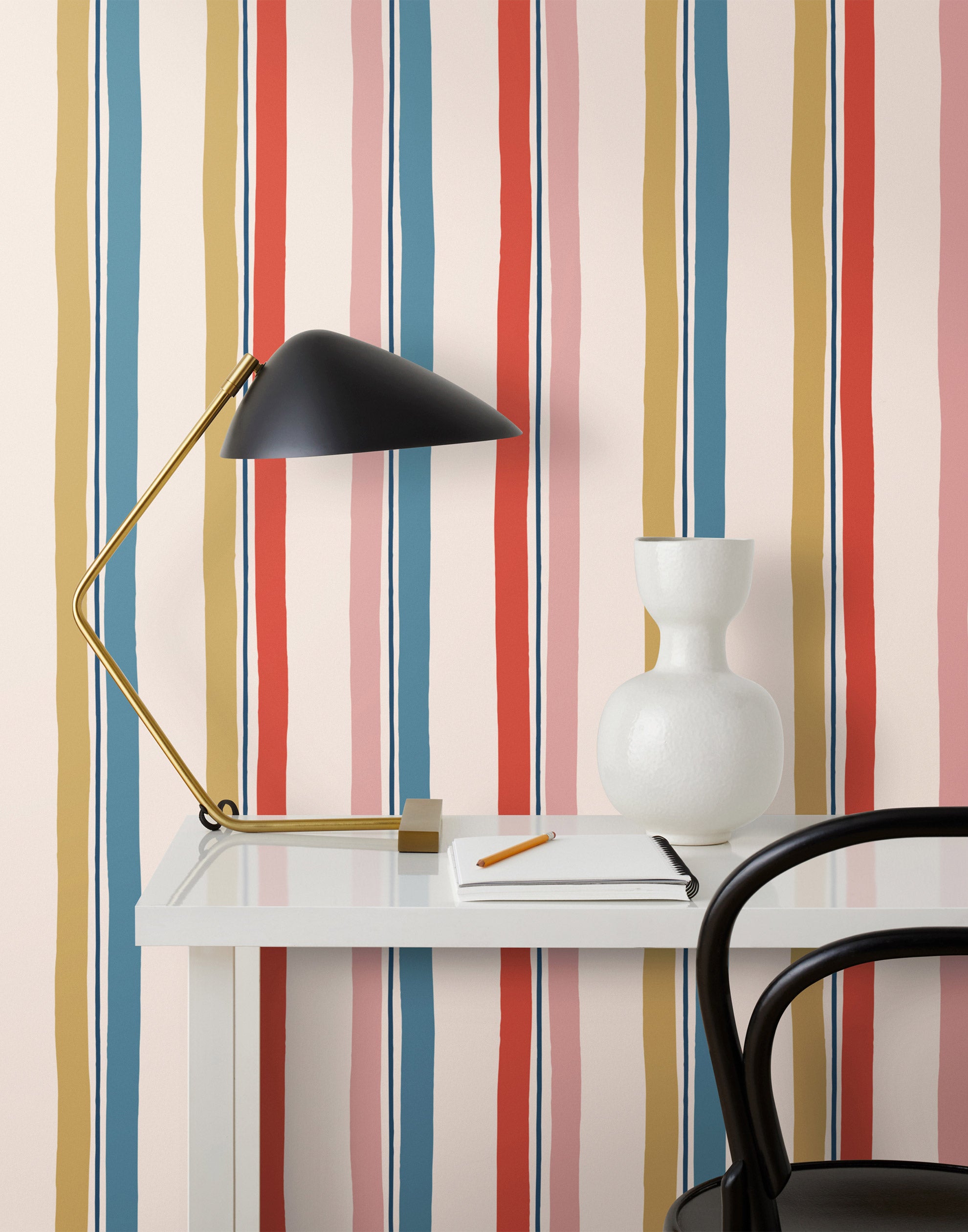 Our Picnic wallpaper was inspired by the wavy stripes of a picnic blanket. Highly durable, fade resistant, and made in the USA. This wallpaper has  blue, red , mustard yellow, and pink stripes on a blush background and was made in collaboration with The Aesthetics of Joy.