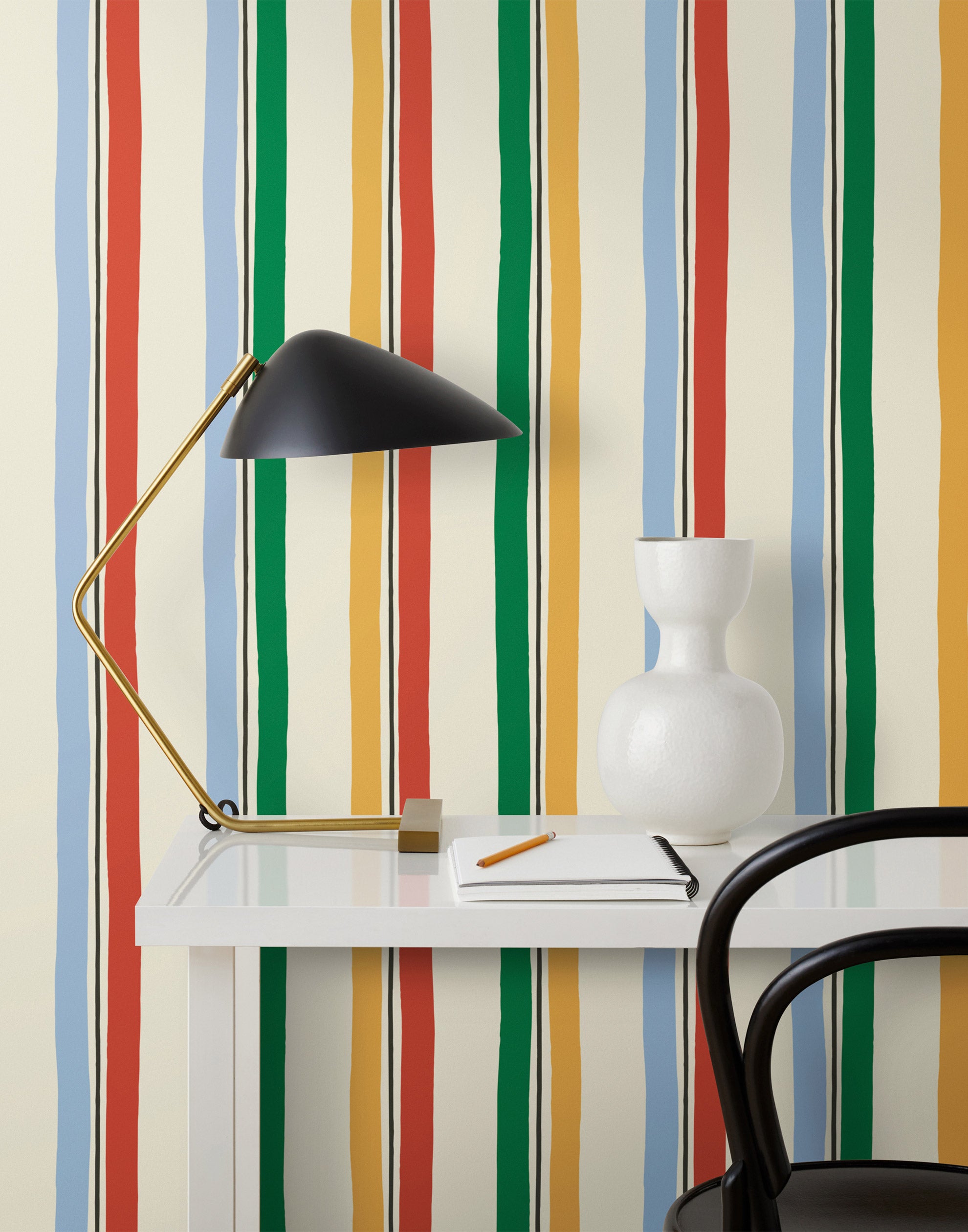 Our Picnic wallpaper was inspired by the wavy stripes of a picnic blanket. Highly durable, fade resistant, and made in the USA. This wallpaper has green, blue, red and yellow stripes on a cream background and was made in collaboration with The Aesthetics of Joy.