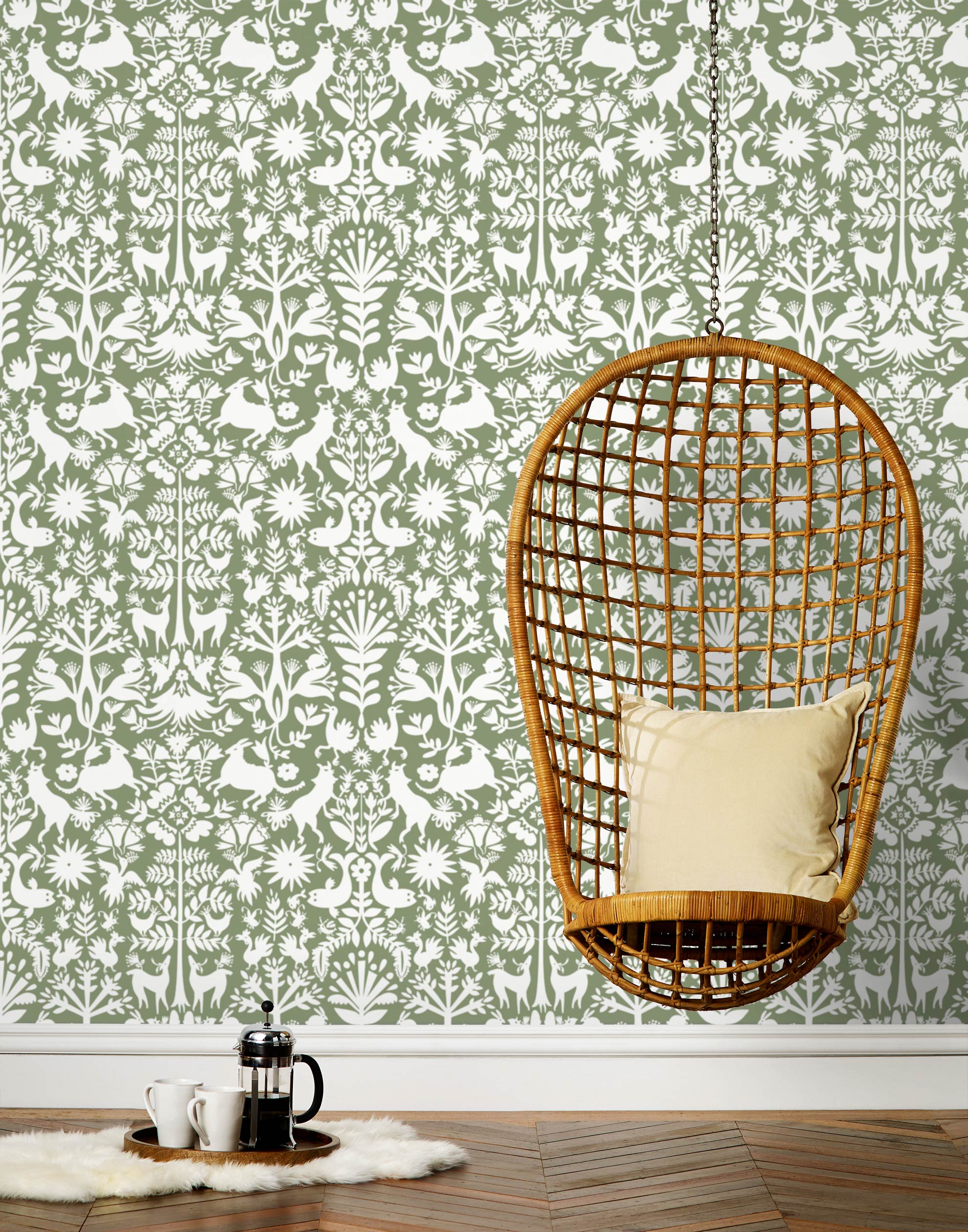 Folklore (Fern) features white animals and flowers in a mirroring pattern on a soft green backgroud designed by Emily Isabella for Hygge & West