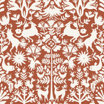 Folklore (Terracotta) features white animals and flowers in a mirroring pattern on a terracotta red backgroud designed by Emily Isabella for Hygge & West