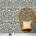 Folklore (Sage) features white animals and flowers in a mirroring pattern on a sage green backgroud designed by Emily Isabella for Hygge & West