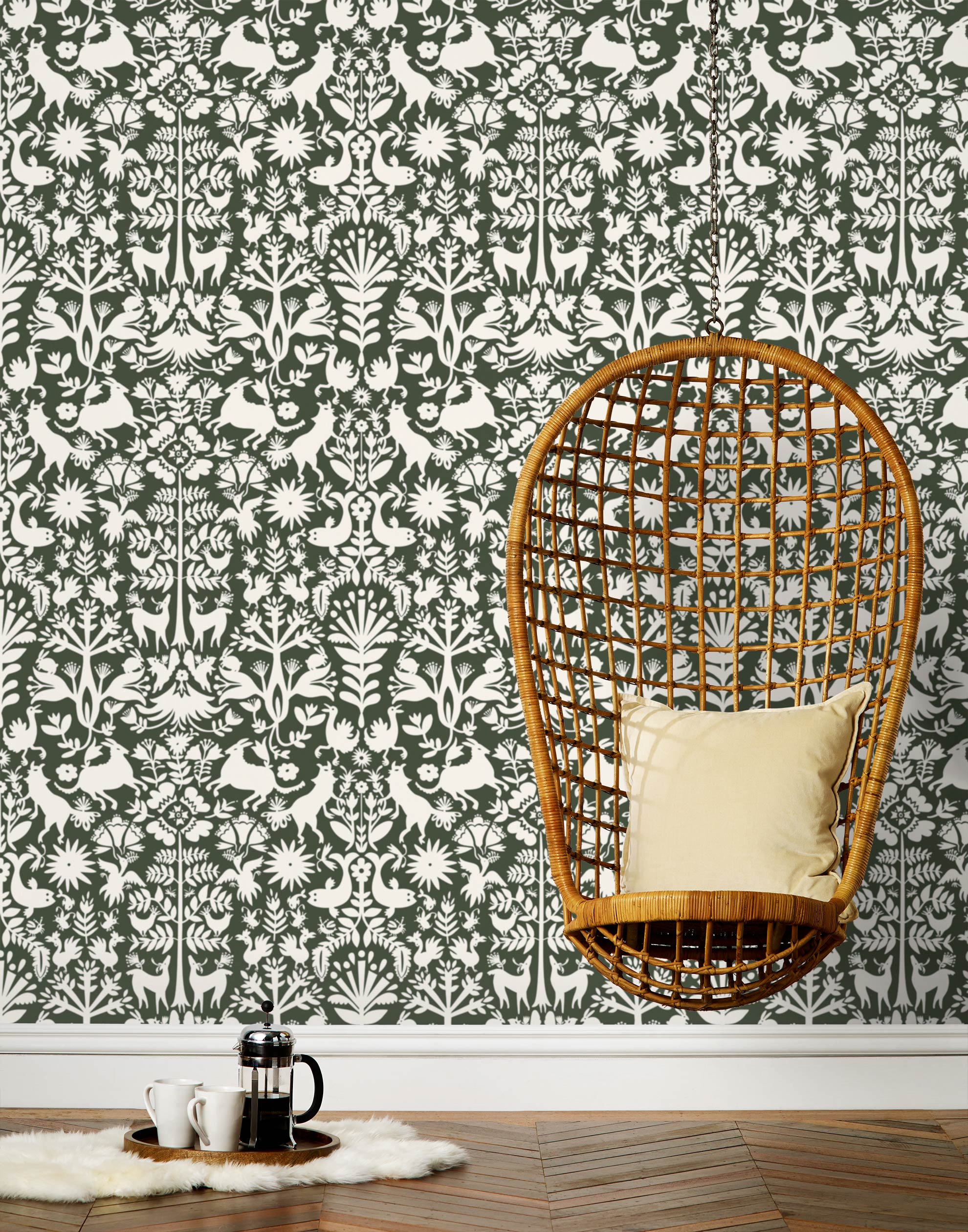 Folklore (Sage) features white animals and flowers in a mirroring pattern on a sage green backgroud designed by Emily Isabella for Hygge & West