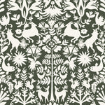 Folklore (Sage) features white animals and flowers in a mirroring pattern on a sage green backgroud designed by Emily Isabella for Hygge & West