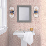 Storyline (Blush) Wallpaper | Folk art inspired pattern featuring flora and fauna in dusty pink on a soft pink ground