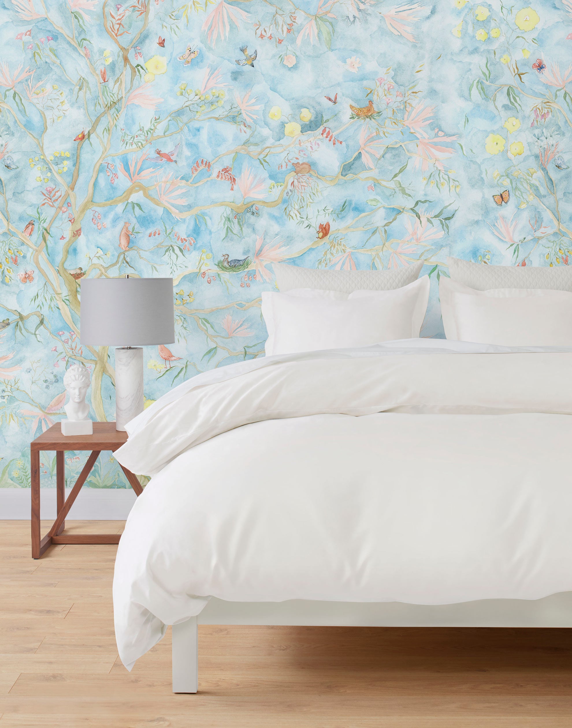 Watercolored birds, butterflies and tree sprites flutter about in an orchard of trees in our Tree Sprites mural. Yellow, pink, peach, and green on a soft blue background. Hillery Sproat + Hygge & West