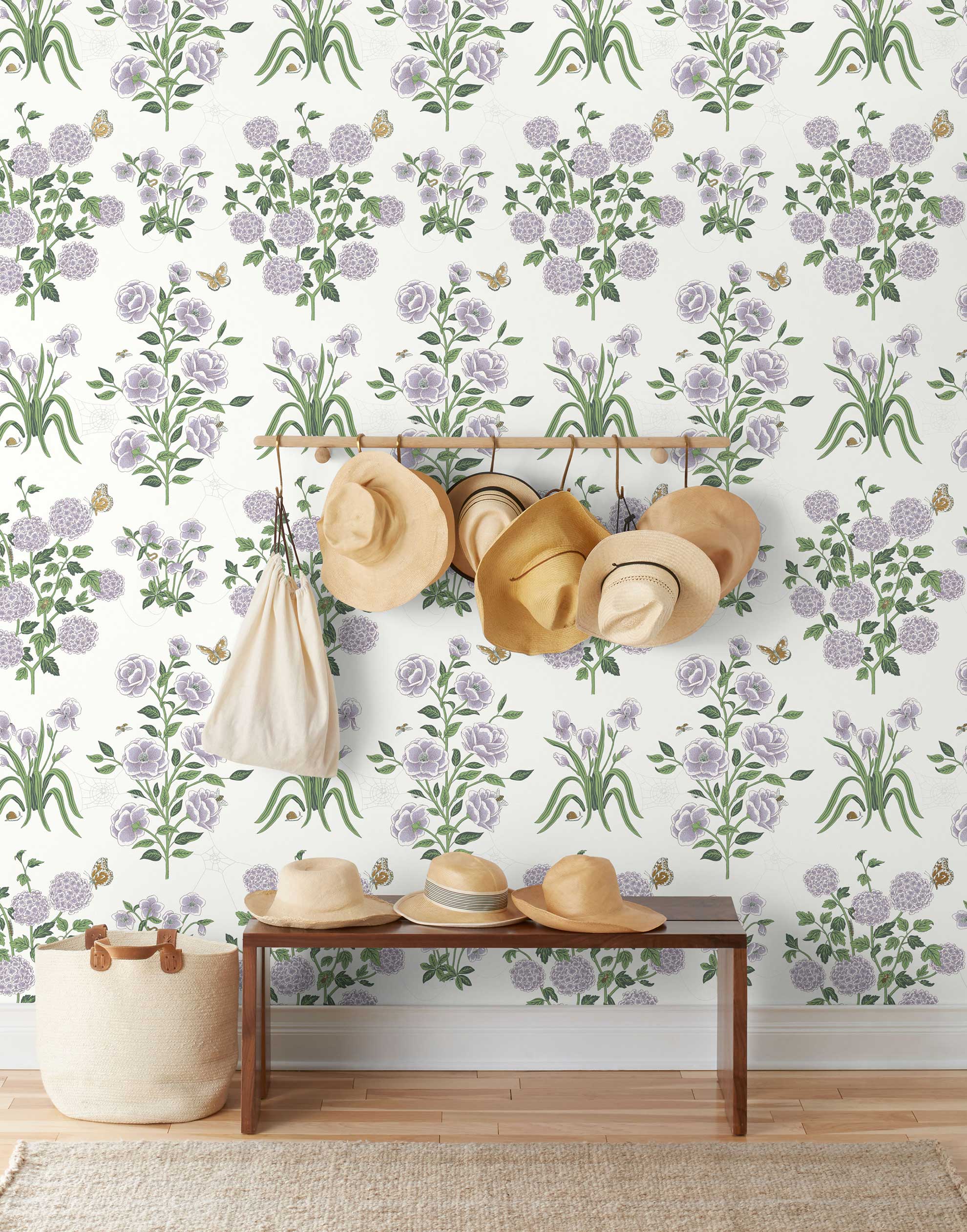 This large-scale wallpaper features hand drawn bees, butterflies and other garden friends frolic among flowers - camellias, hellebores, irises, and snowball trees. Harmony (Ebony) is printed in shades of green and purple on a white background.