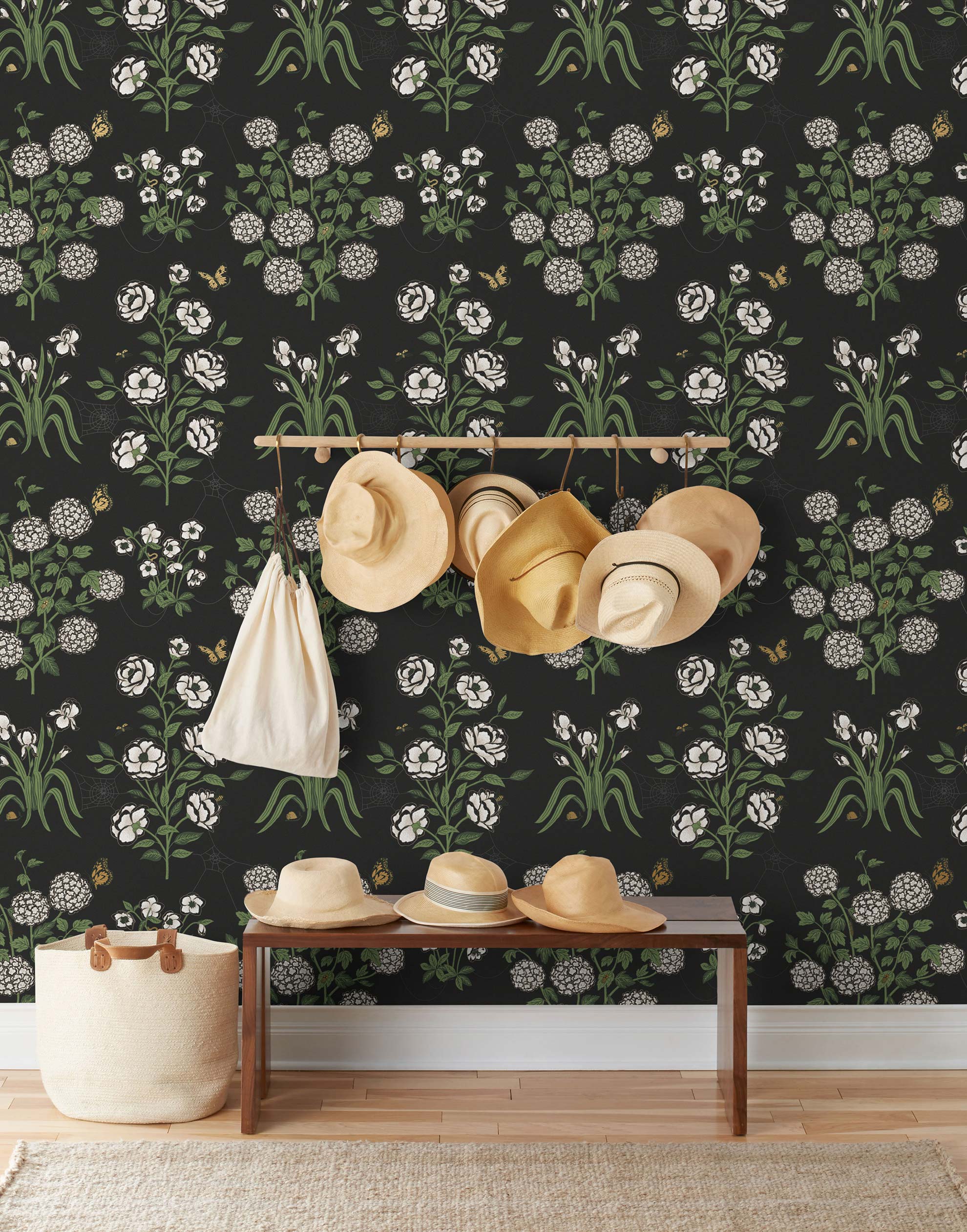 This large-scale wallpaper features hand drawn bees, butterflies and other garden friends frolic among flowers - camellias, hellebores, irises, and snowball trees. Harmony (Ebony) is printed in shades of green and white on a black background.