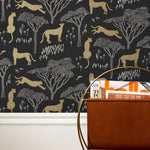 Our Serengeti wallpaper features gold cheetahs and gray birds scattered among gray acacia trees on a black background, reflecting the powerful beauty of the vast plains. Designed by Julia Rothman and made in the USA.