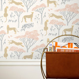 Our Serengeti wallpaper features beige cheetahs and pink birds scattered among peach acacia trees on a white background, reflecting the powerful beauty of the vast plains. Designed by Julia Rothman and made in the USA.