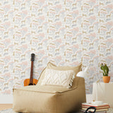 Our Serengeti wallpaper features beige cheetahs and pink birds scattered among peach acacia trees on a white background, reflecting the powerful beauty of the vast plains. Designed by Julia Rothman and made in the USA.