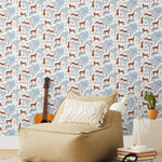 Our Serengeti wallpaper features orange cheetahs and navy birds scattered among blue acacia trees on a white background, reflecting the powerful beauty of the vast plains. Designed by Julia Rothman and made in the USA.