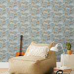 Our Serengeti wallpaper features brown cheetahs and birds scattered among white acacia trees on a dusty blue background, reflecting the powerful beauty of the vast plains. Designed by Julia Rothman and made in the USA.