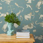 Our In the Stars wallpaper is inspired by Urania’s Mirror, a 19th-century set of astrology charts. This hand-drawn pattern evokes the mysterious motion of celestial bodies. This wallpaper features cream and gold motifs on a blue background and was designed by Julia Rothman.