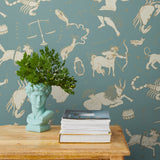 Our In the Stars wallpaper is inspired by Urania’s Mirror, a 19th-century set of astrology charts. This hand-drawn pattern evokes the mysterious motion of celestial bodies. This wallpaper features cream and gold motifs on a blue background and was designed by Julia Rothman.