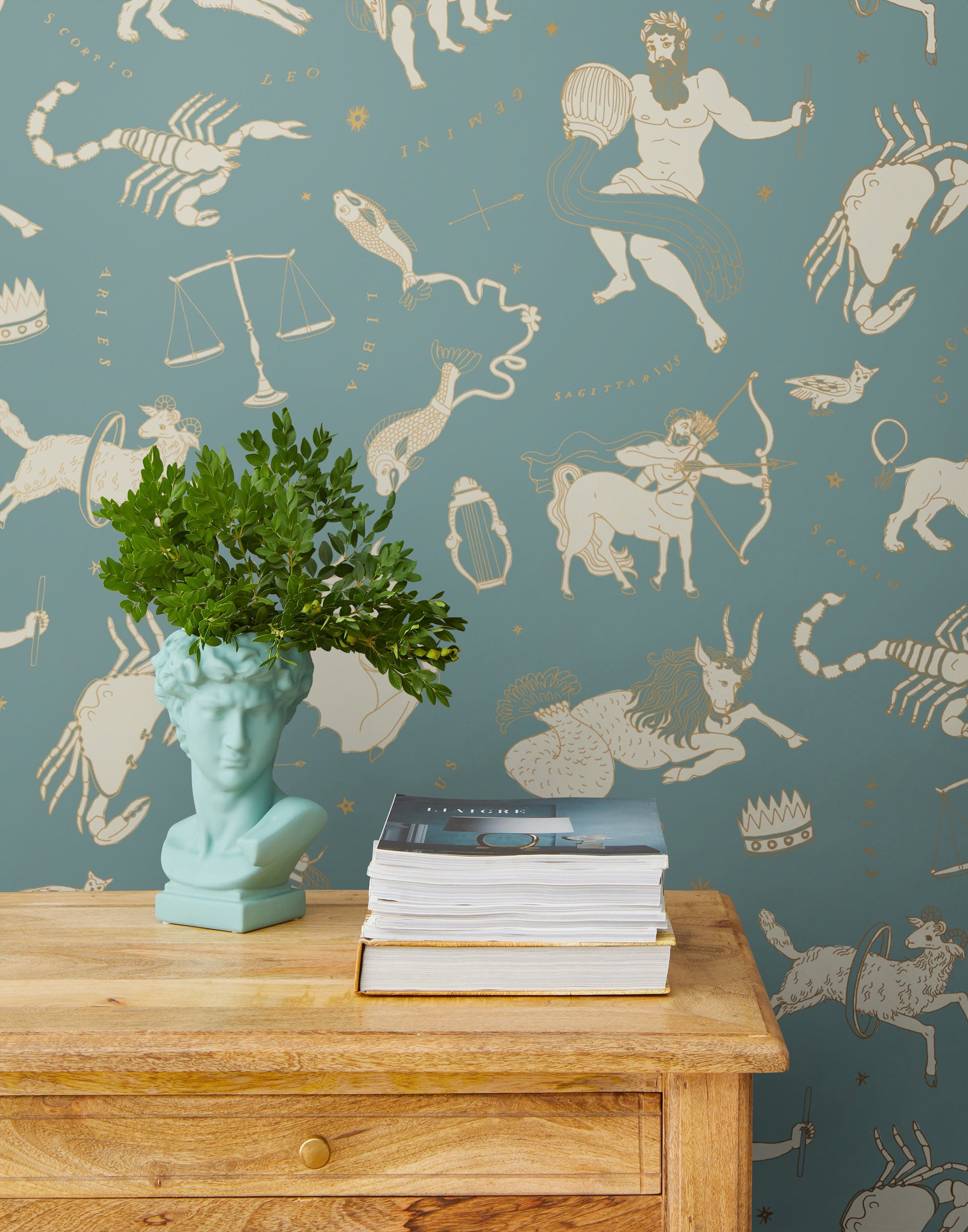 Our In the Stars wallpaper is inspired by Urania’s Mirror, a 19th-century set of astrology charts. This hand-drawn pattern evokes the mysterious motion of celestial bodies. This wallpaper features cream and gold motifs on a blue background and was designed by Julia Rothman.