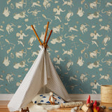 Our In the Stars wallpaper is inspired by Urania’s Mirror, a 19th-century set of astrology charts. This hand-drawn pattern evokes the mysterious motion of celestial bodies. This wallpaper features cream and gold motifs on a blue background and was designed by Julia Rothman.