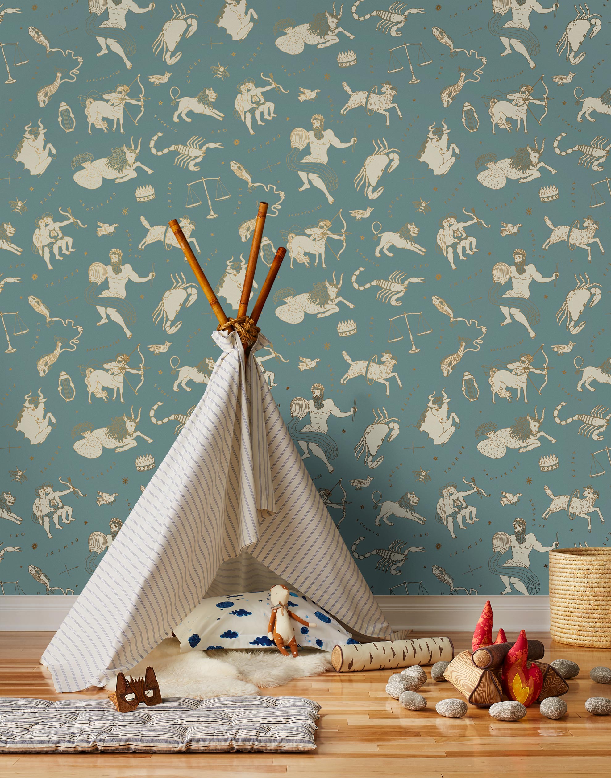 Our In the Stars wallpaper is inspired by Urania’s Mirror, a 19th-century set of astrology charts. This hand-drawn pattern evokes the mysterious motion of celestial bodies. This wallpaper features cream and gold motifs on a blue background and was designed by Julia Rothman.