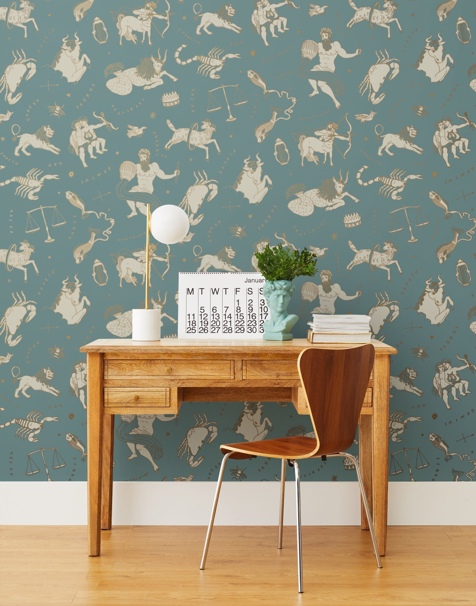 Our In the Stars wallpaper is inspired by Urania’s Mirror, a 19th-century set of astrology charts. This hand-drawn pattern evokes the mysterious motion of celestial bodies. This wallpaper features cream and gold motifs on a blue background and was designed by Julia Rothman.