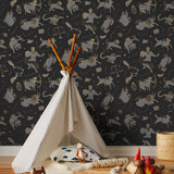 Our In the Stars wallpaper is inspired by Urania’s Mirror, a 19th-century set of astrology charts. This hand-drawn pattern evokes the mysterious motion of celestial bodies. This wallpaper features gray and gold motifs on a black background and was designed by Julia Rothman.