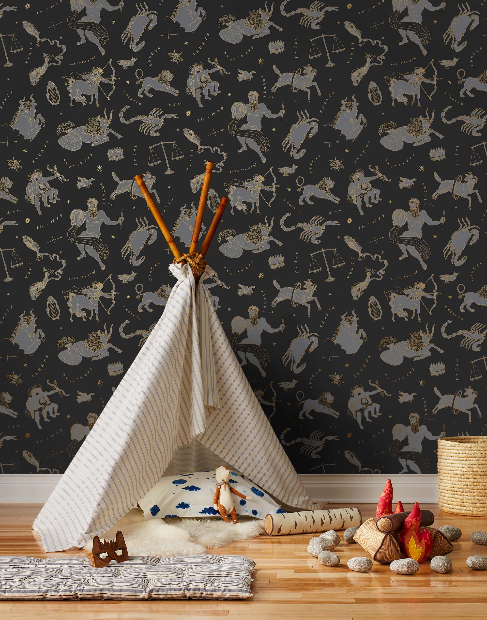 Our In the Stars wallpaper is inspired by Urania’s Mirror, a 19th-century set of astrology charts. This hand-drawn pattern evokes the mysterious motion of celestial bodies. This wallpaper features gray and gold motifs on a black background and was designed by Julia Rothman.