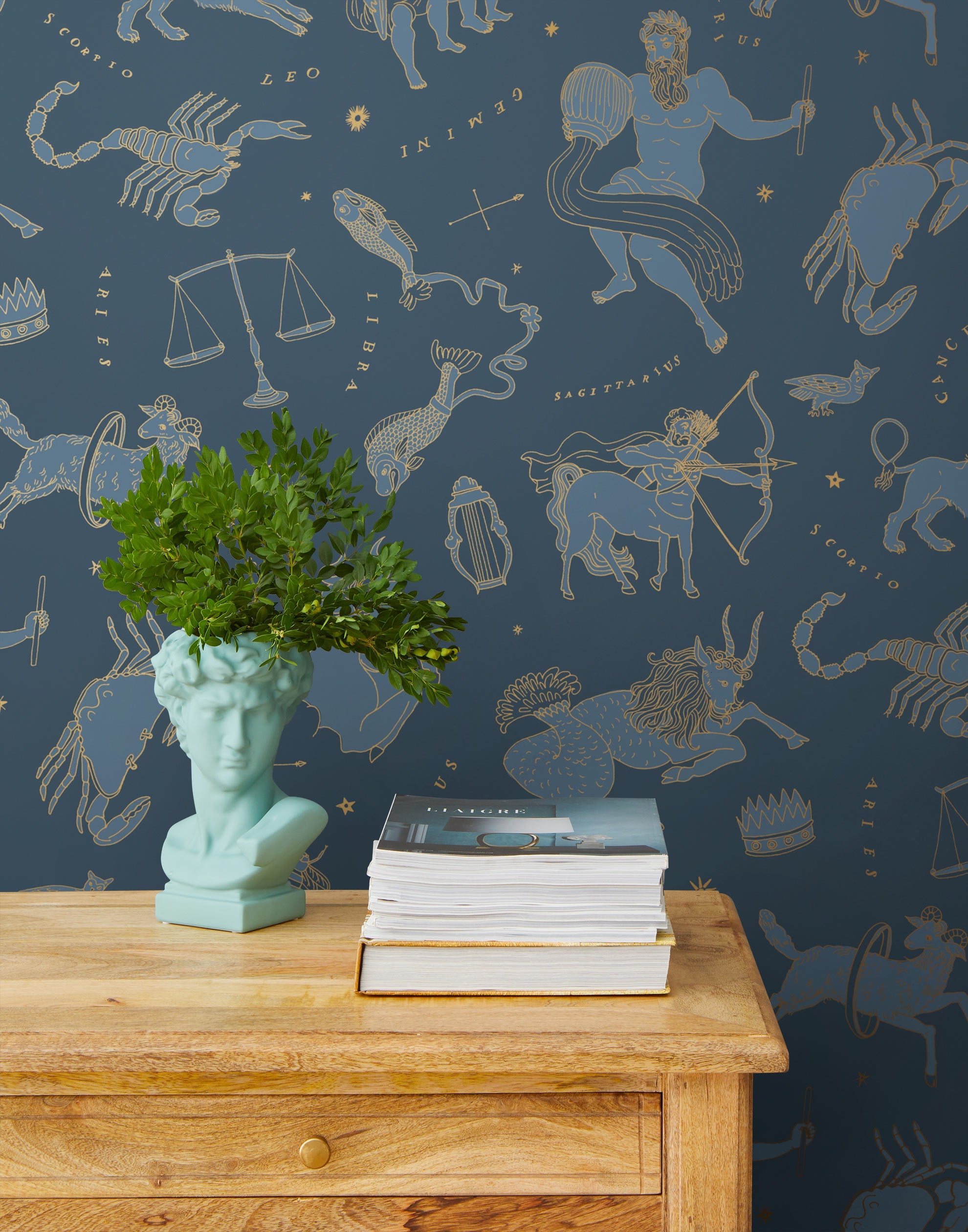 Our In the Stars wallpaper is inspired by Urania’s Mirror, a 19th-century set of astrology charts. This hand-drawn pattern evokes the mysterious motion of celestial bodies. This wallpaper features blue and gold motifs on a navy background and was designed by Julia Rothman.