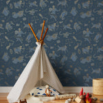 Our In the Stars wallpaper is inspired by Urania’s Mirror, a 19th-century set of astrology charts. This hand-drawn pattern evokes the mysterious motion of celestial bodies. This wallpaper features blue and gold motifs on a navy background and was designed by Julia Rothman.
