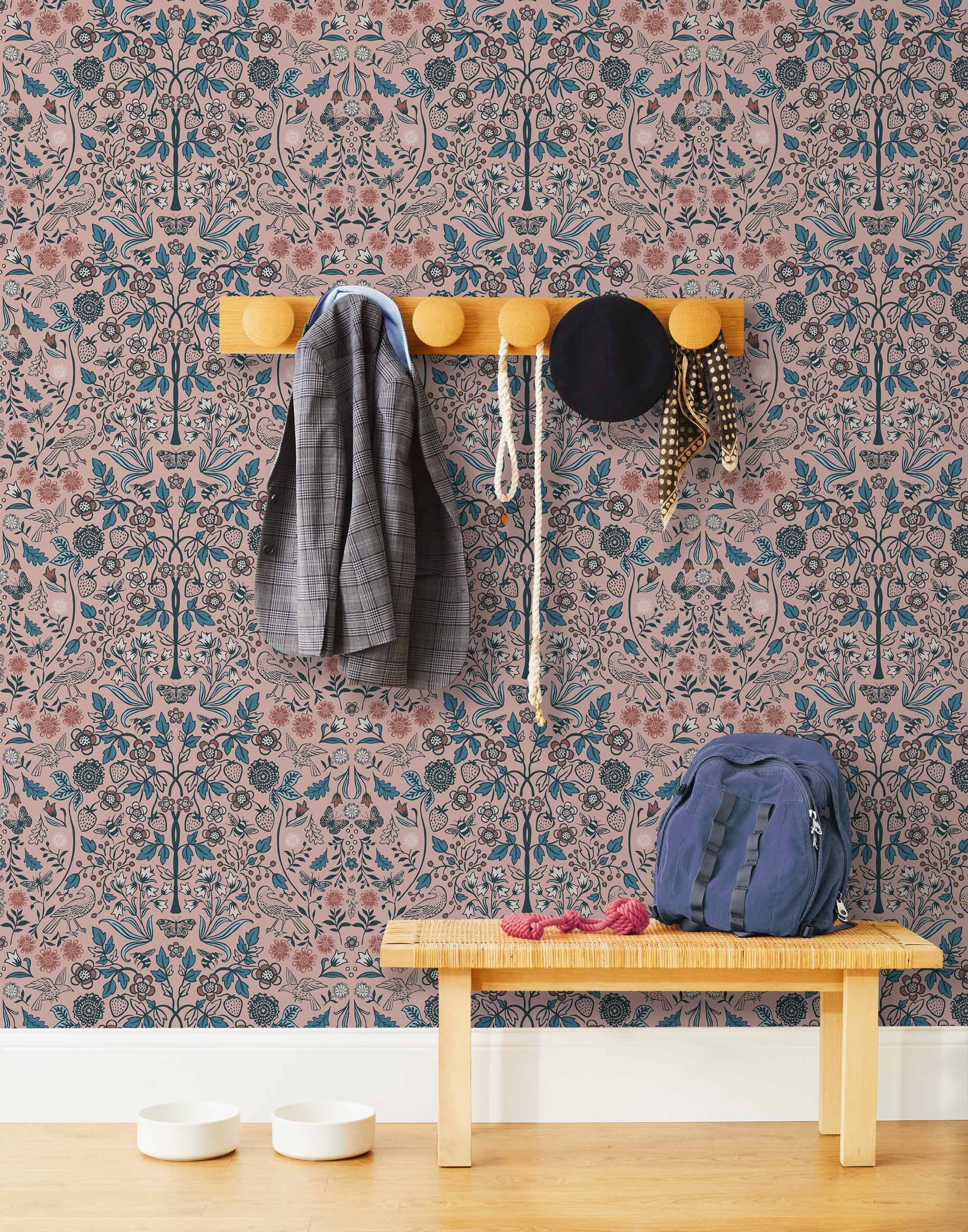 Nora (Rose) wallpaper features a garden of bees, birds, strawberries, and flowers in blue, pink, and white on a dusty pink background.