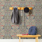 Nora (Taupe) wallpaper features a garden of bees, birds, strawberries, and flowers in shades of blue, pink, and white on a cream background.